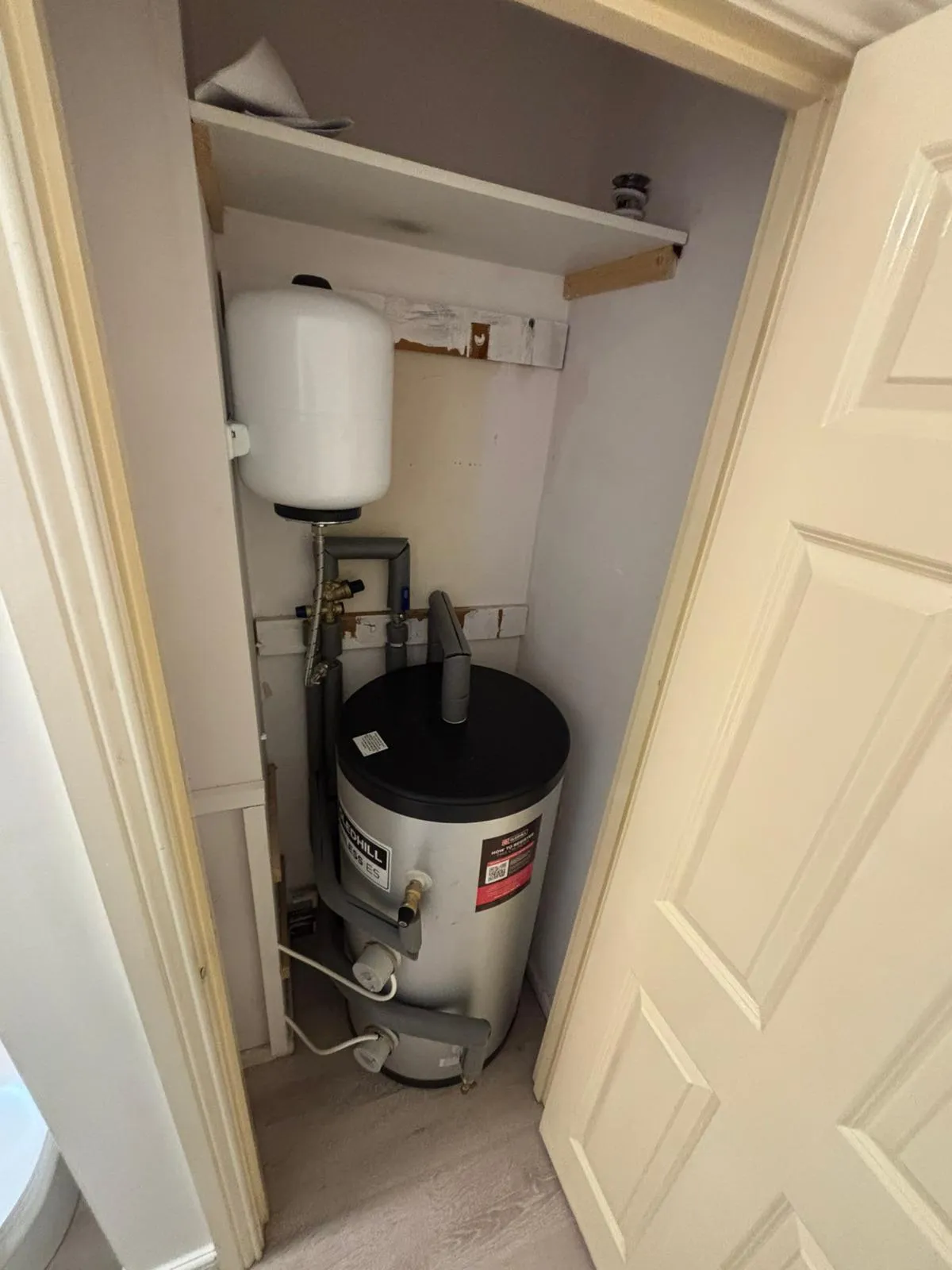 Stainless unvented cylinder fitted in an airing cupboard