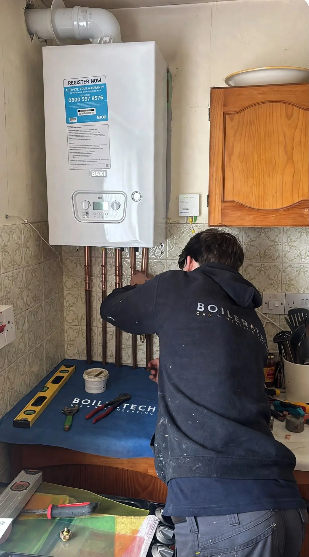 Jack, our apprentice, fitting a new Baxi boiler on his first supervised solo install
